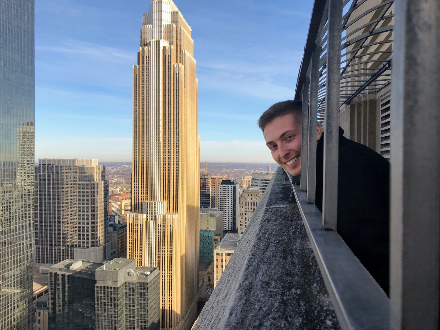 Daniel beside a city skyline