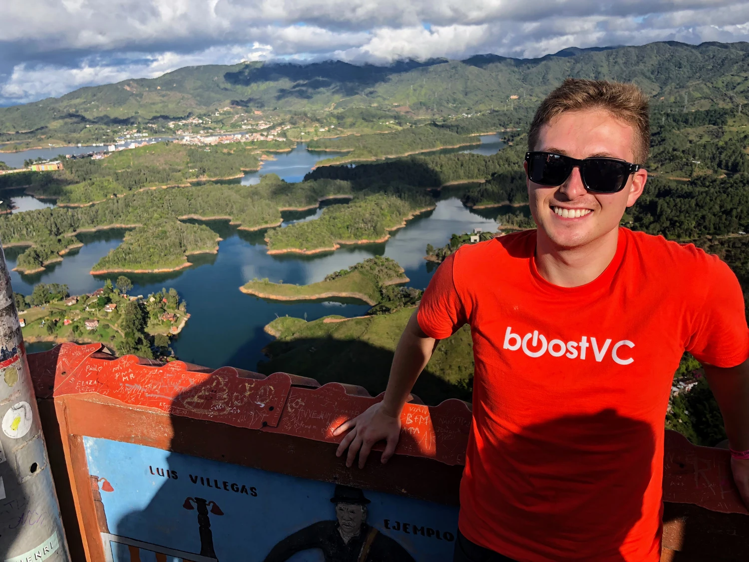 Daniel overlooking a lake and green hills
